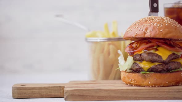Fresh Tasty Burger Served with Soda and French Fries on White Table
