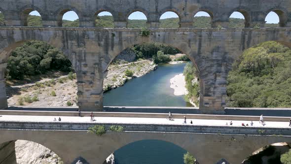 Drone flying through The Pont du Gard, an ancient Roman aqueduct in France