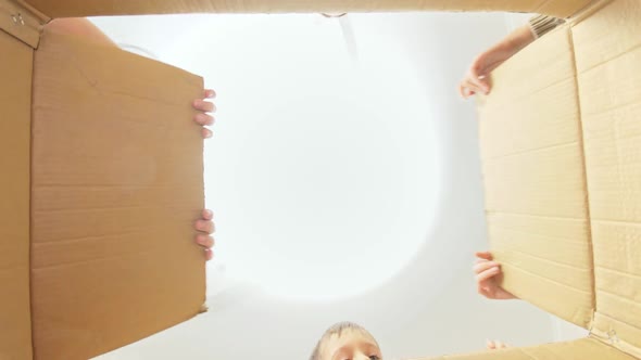 Amazed Big Family Opens Cardboard Box and Looking Inside