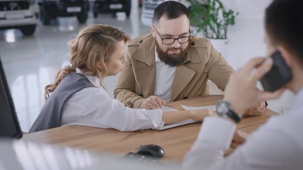 A Married Couple Buys a New Car in a Car Dealership