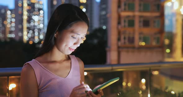 Woman use of mobile phone at night 