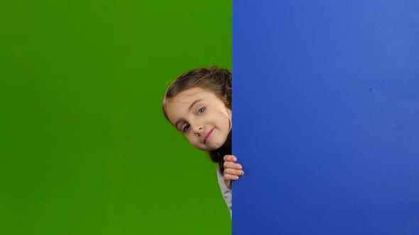 Baby Looks Out From Behind an Empty Board. Green Screen