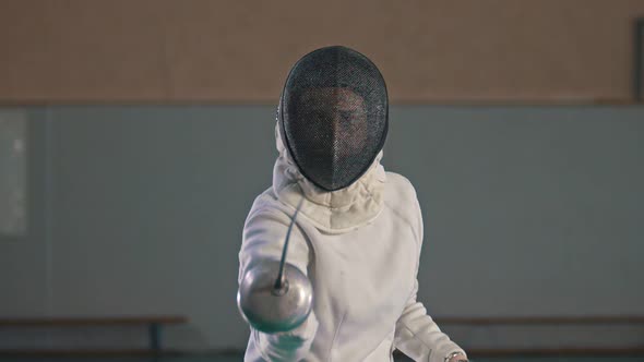 A Young Woman Fencer Making Lunges To the Camera