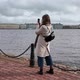 A Young Woman with a Mobile Phone in Her Hands Takes Pictures of the Embankment of the Neva River in - VideoHive Item for Sale