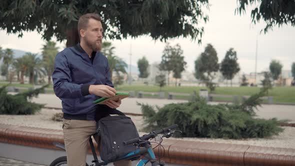 Man with Tablet on a Bike