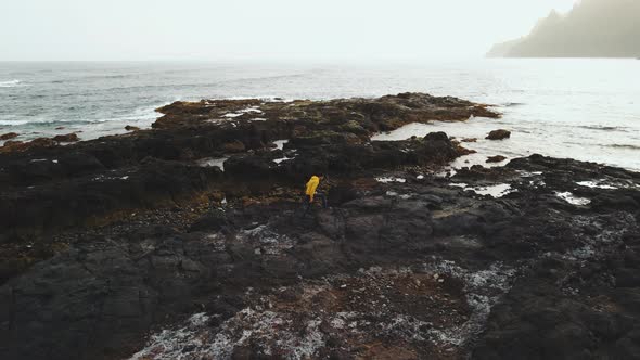 Tourist Man in Yellow Sweatshirt Walks on Volcanic Beach in North of Canary Island Tenerife