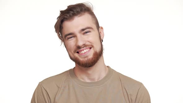 Handsome Caucasian Male with Brown Beard Smiling Laughing Standing on White Background in Slowmotion
