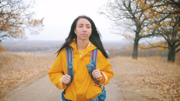 Woman Traveler with Backpack Hiking in Mountains. Hiker Walking in the Mountains, Freedom and