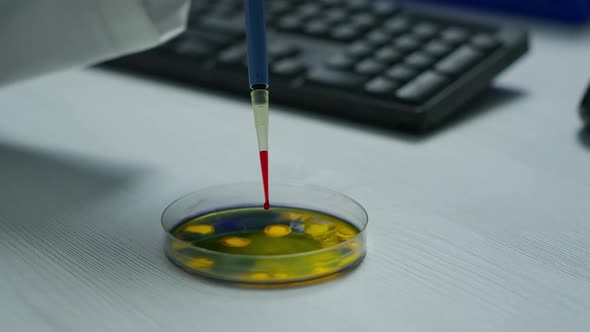 Close Up of Scientist Using Micropipette for Analysing Blood Sample