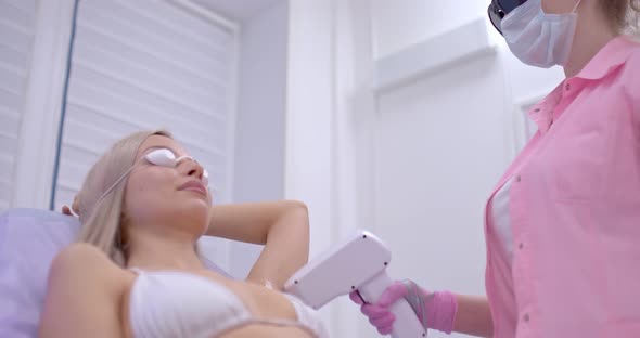Beautician Makes Laser Hair Removal in a Beauty Salon