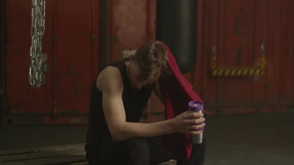 Healthy Lifestyle Man Resting After Workout in Gym