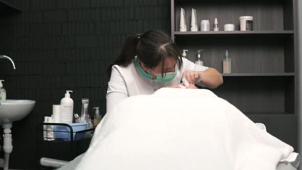 Cosmetologist Woman Cleanses the Face of Acne and Blackheads Mechanically