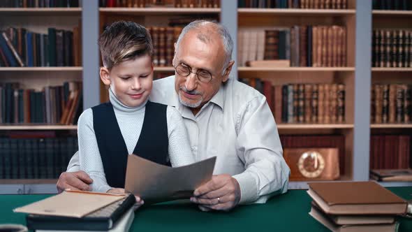 70s Grandfather Help Doing Homework Little Cute Male Grandkid Sitting on Vintage Table Home Library