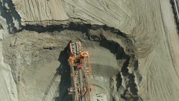 Aerial View of Bucket Wheel Excavator in Process of Mining Natural Resource. Heavy Industry.