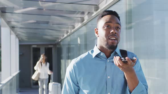 Video of african american man walking and using smartphone