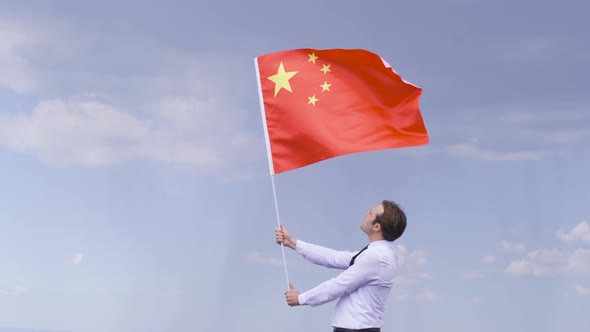 Young man waving the Chinese flag.