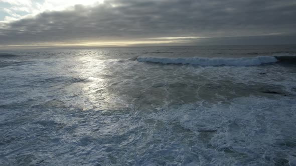 Ocean Waves Splash at Sunset Light