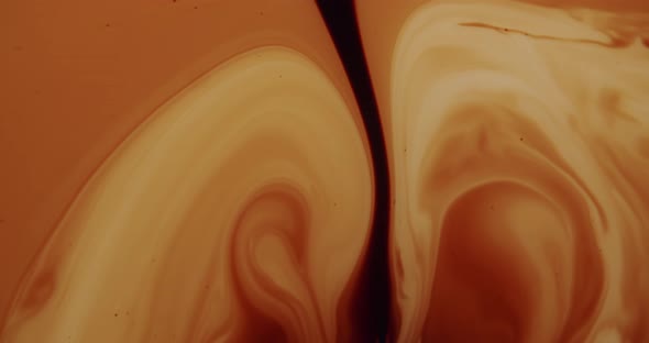 Top shot of a liquid forming organic shapes. Black stream in the middle of the frame. Liquid looking alt