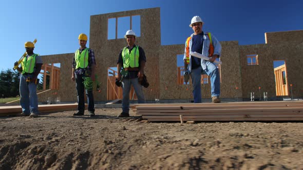 Group of construction workers standing in front of job site