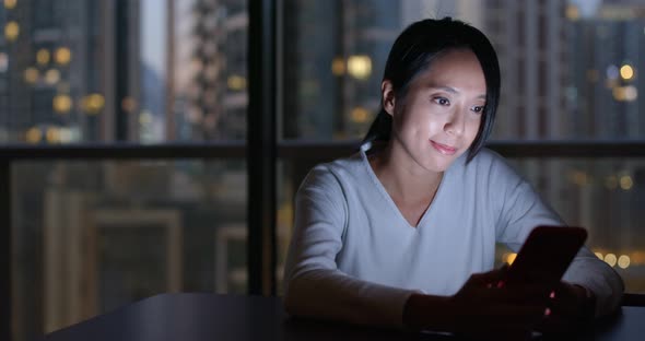 Woman watch on mobile phone at home