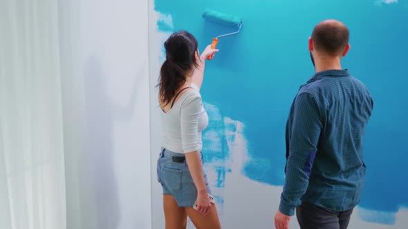 Adults Painting Wall