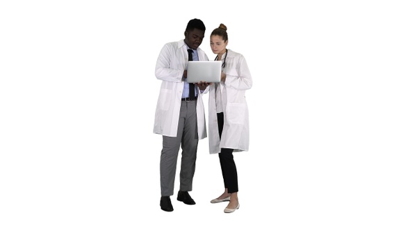 Medical staff working in front of a grey laptop while standing