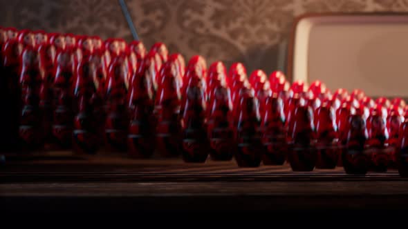 Handmade matryoshka dolls on a desk. A huge number of Babushkas jumping together