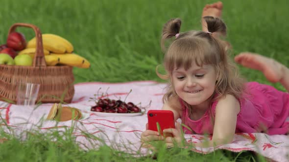 Weekend at Picnic. Girl on Grass Meadow Play Online Games on Mobile Phone. Social Network, Chatting