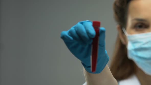 Female Doctor Holding Test Tube With Blood Sample, Infectious Disease Awareness