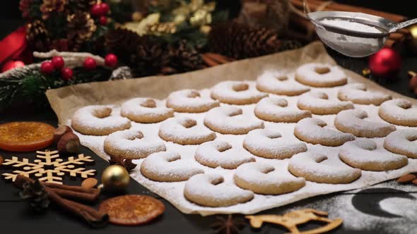 Woman Sprinkles Sugar Powder on Traditional German or Austrian Vanillekipferl Vanilla Kipferl