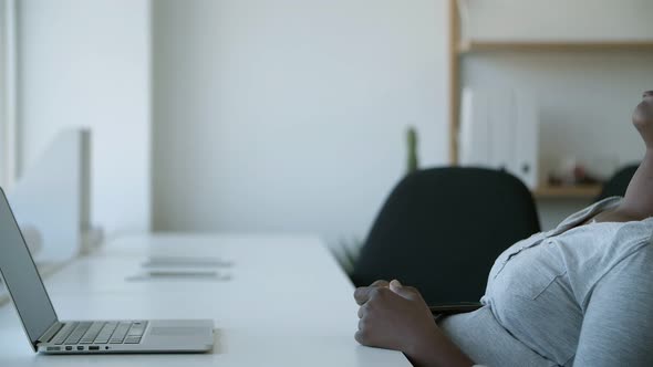 Tired Worker Sleeping in Chair