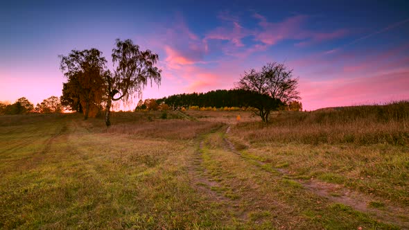 Beautiful Time Lapse with Colorful Sunset Sky Over Meadow and Trees