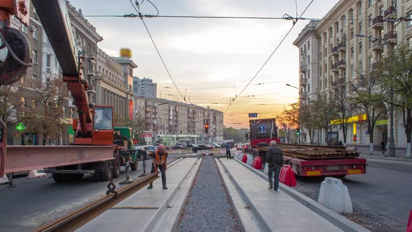 Orange Construction Telescopic Mobile Crane Unloading Tram Rails From Truck Timelapse