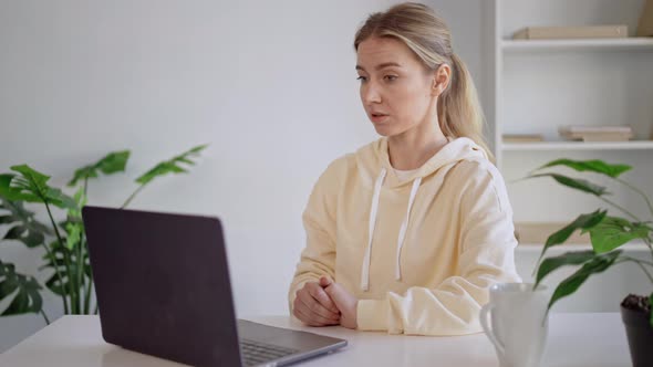 Worker Remote Meeting Using Webcam on Computer at Workplace