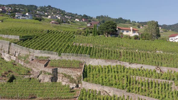 Drone flying over hills in a small suburban town in Switzerland