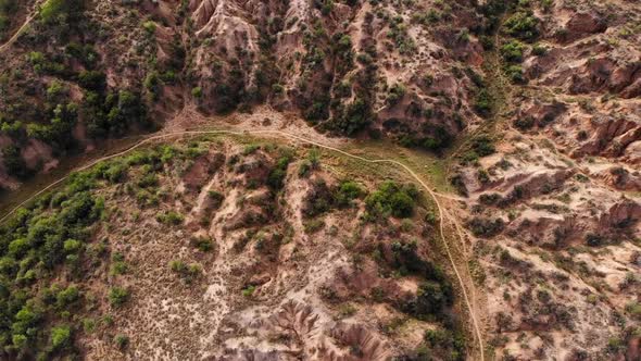 Drone Shot Circling Mountain Bikers in a Canyon on a Sunny Day