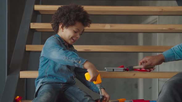 Little Boy Learning Work Tools at Home Shop Class