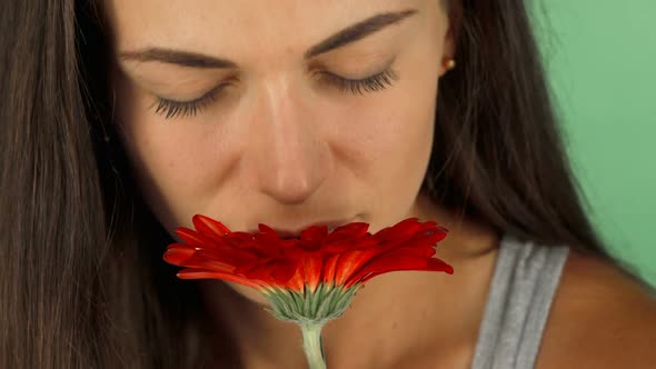 Beautiful Young Woman Smiling Joyfully While Smelling a Flower 1080p