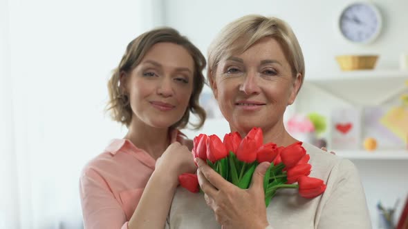 Happy Females Looking in Camera Holding Tulip Flowers, International Women Day