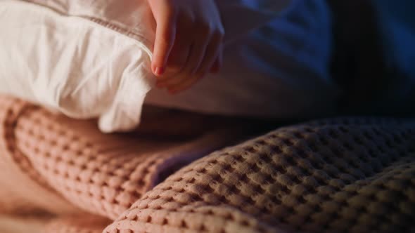 Little Kid Takes Large Pillow in Case on Bed with Blanket