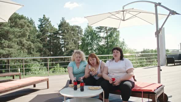 Three Fatty Women Having Fast Food Lunch