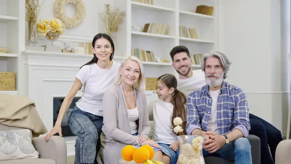 Big Happy Family Talking By Video Call or Taking Selfie While Sitting on Sofa at Home