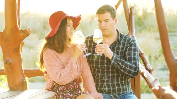 Couple in Vineuard Clinking Glasses with Wine