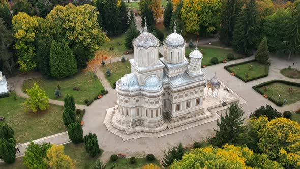 Aerial drone view of The Cathedral of Curtea de Arges, Romania. Square with greenery