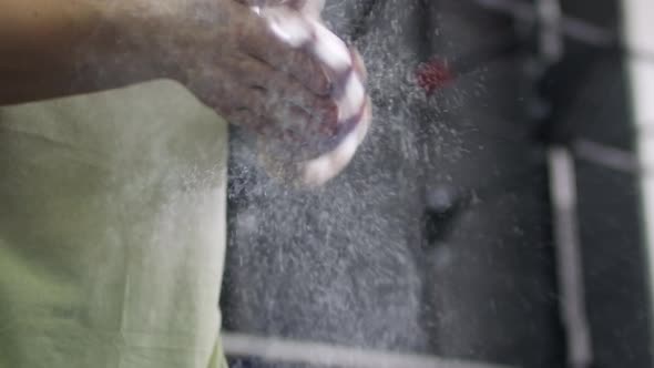 Female Athlete Putting Talcum Powder on Hands