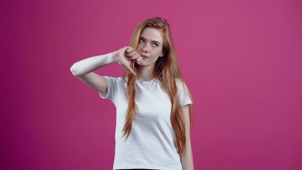 The Portrait of a Dissatisfied Redhead Who Shows the Sign of Dislike with Both Hands