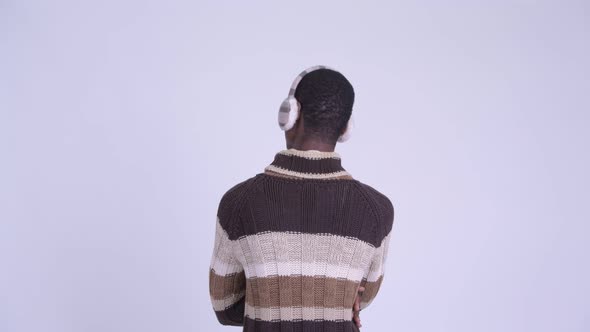 Rear View of Young African Man Pointing Finger Ready for Winter