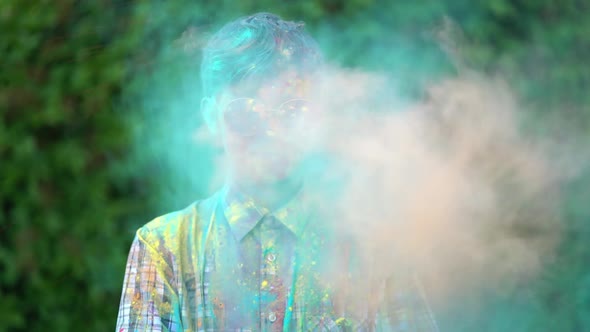 Portrait of Boy Standing Being Covered in Coloured Powder at Holi Festival