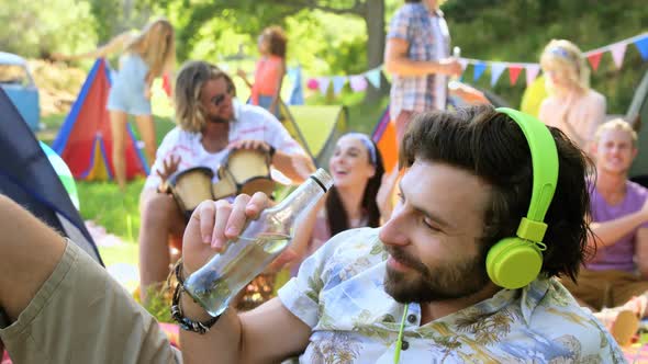 Hipster man listening music and drinking
