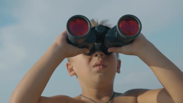 Child exploring the world with binoculars